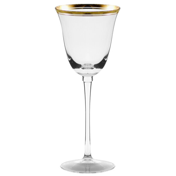 A clear wine glass with a long stem and gold rim.