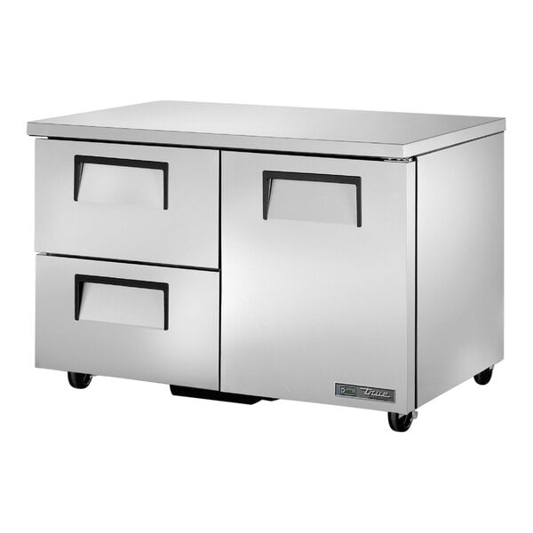 A stainless steel True undercounter refrigerator with one door and two drawers.