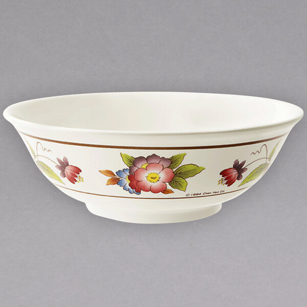 A white melamine bowl with tea rose designs on it.