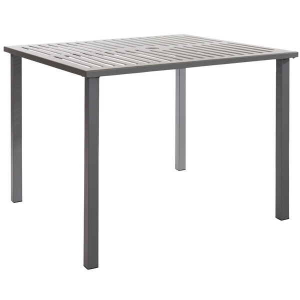 A BFM Seating Daytona dining table with a soft gray powder-coated metal slat top.