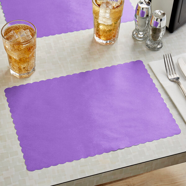 A lavender scalloped edge paper placemat on a table with a fork and a glass of iced tea.
