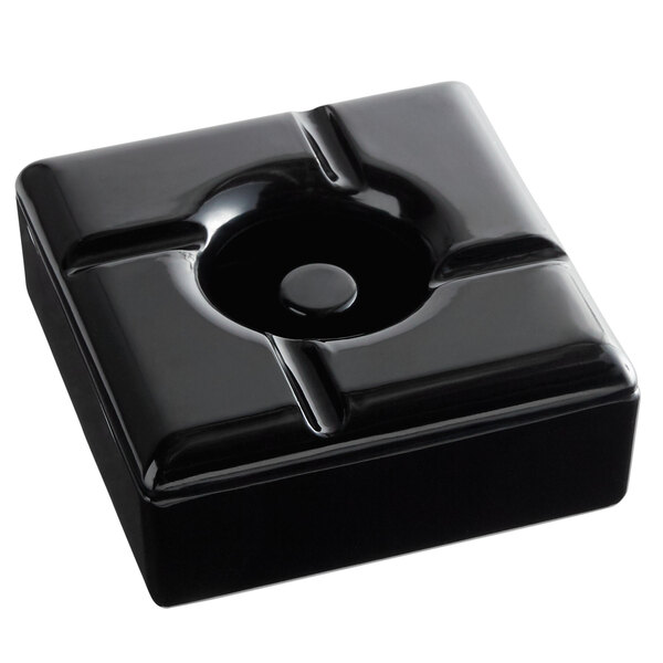 A Tablecraft black square ashtray with a round hole on a counter.