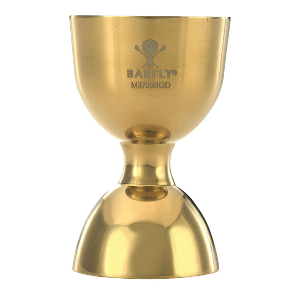 A close-up of a gold-plated Barfly bell jigger with a logo on it.