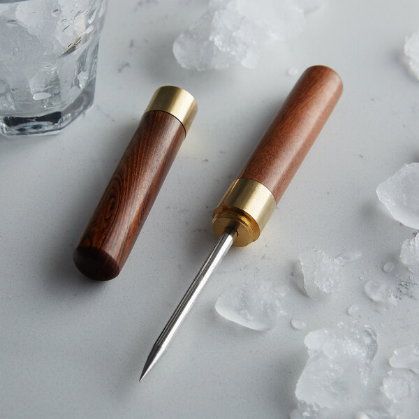 Two wooden and metal Barfly ice picks on a table with ice.