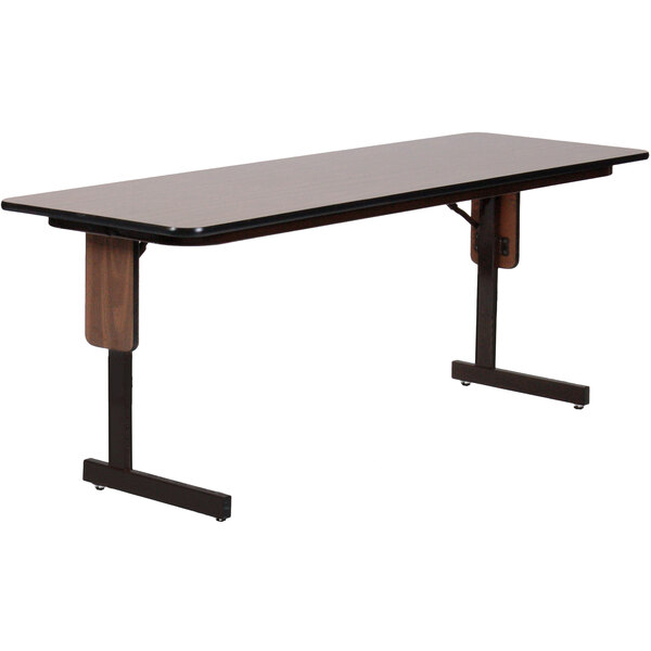 A rectangular table with a walnut top and black panel legs.