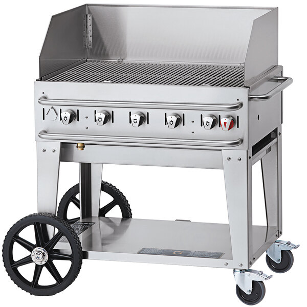 A Crown Verity stainless steel portable outdoor grill on a cart with a stainless steel top.