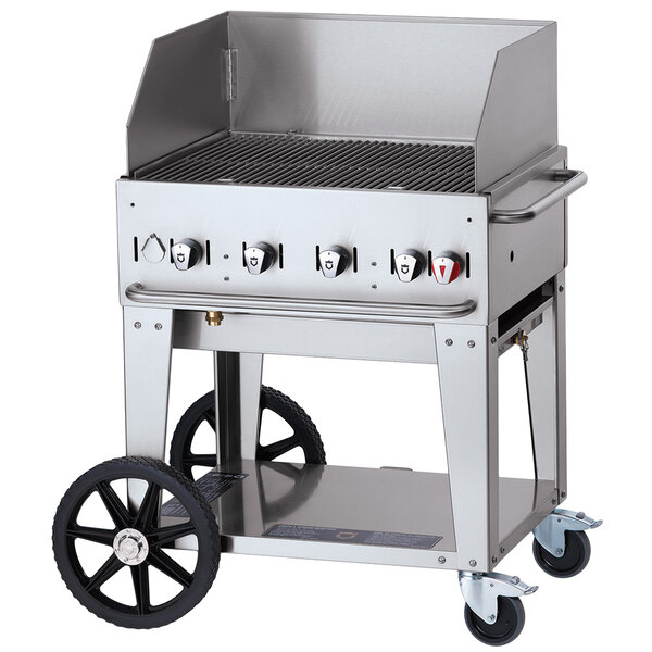 A Crown Verity stainless steel mobile grill with a lid on a cart with wheels.