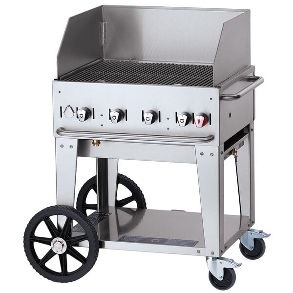 A Crown Verity stainless steel mobile outdoor grill on a cart with a lid.