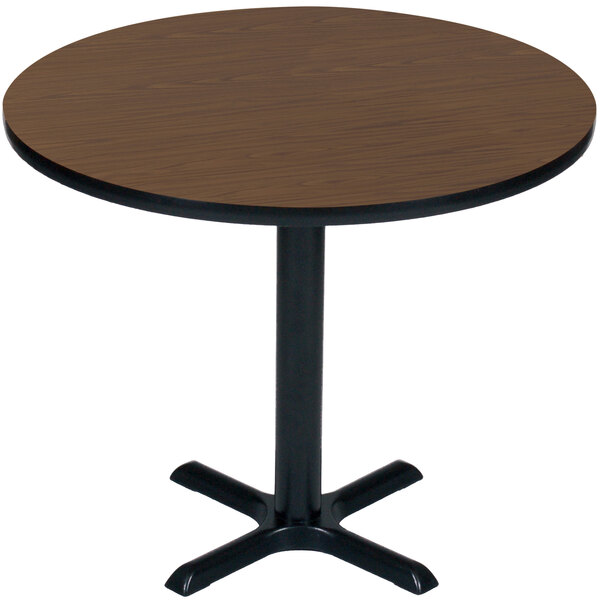 A Correll round table with a walnut finish top and black base.