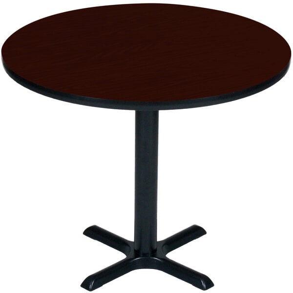 A Correll round table with mahogany top and black base.