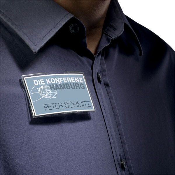 A man wearing a close-up Durable clear acrylic convex horizontal badge holder with a name tag on his shirt.