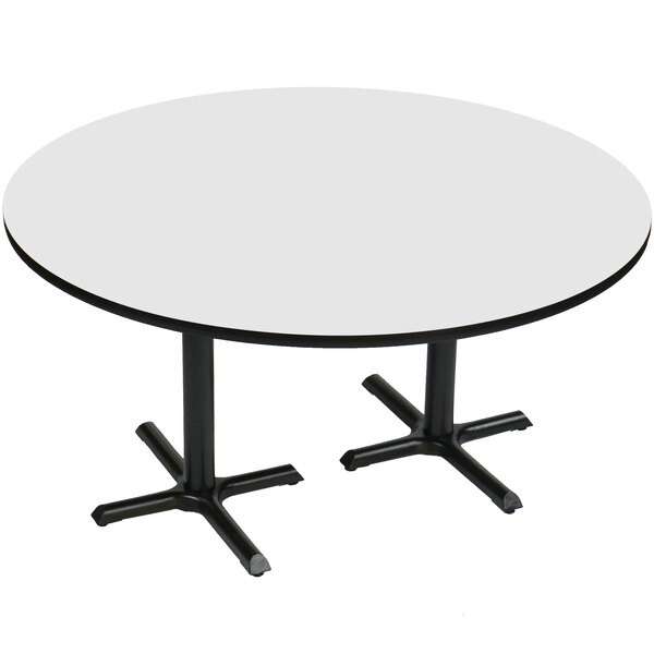 A Correll white round table with two black metal cross bases.