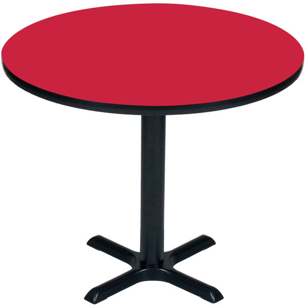 A Correll round red table with a black base.