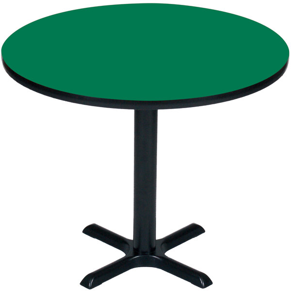 A Correll round table with a green top and black base.