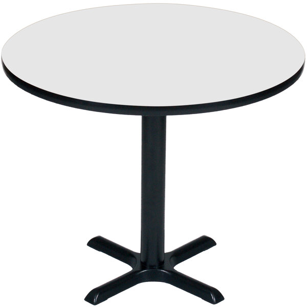 A Correll round table with a black base and white top.