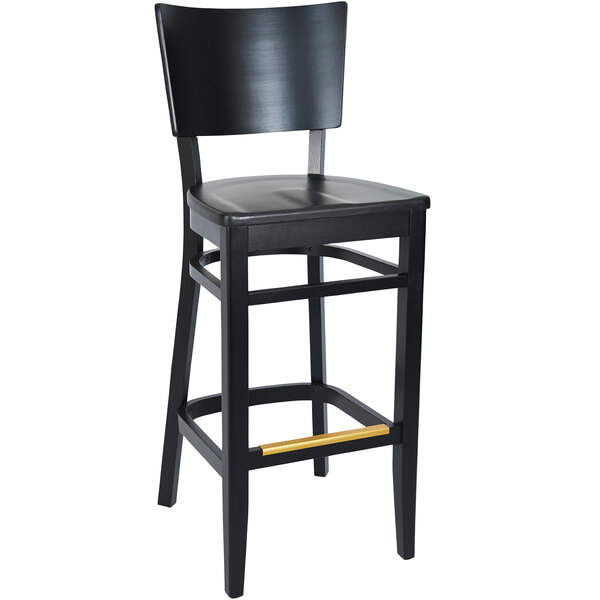 A black BFM Seating barstool with a wooden seat and gold trim.