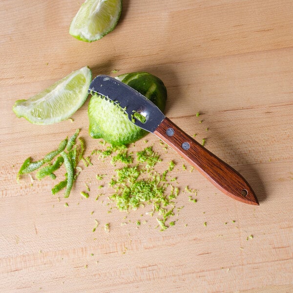 An American Metalcraft citrus zester zesting a lime slice.