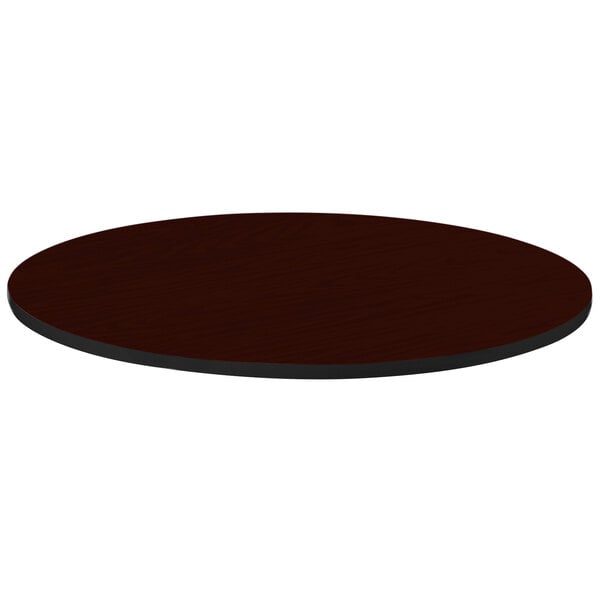 A close-up of a brown Correll round table top with a black edge.