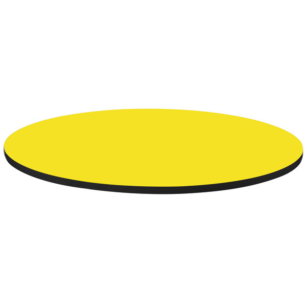 A yellow round table top with black trim.