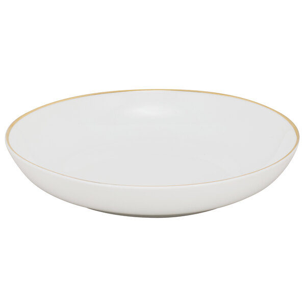 A white porcelain soup bowl with gold rim.
