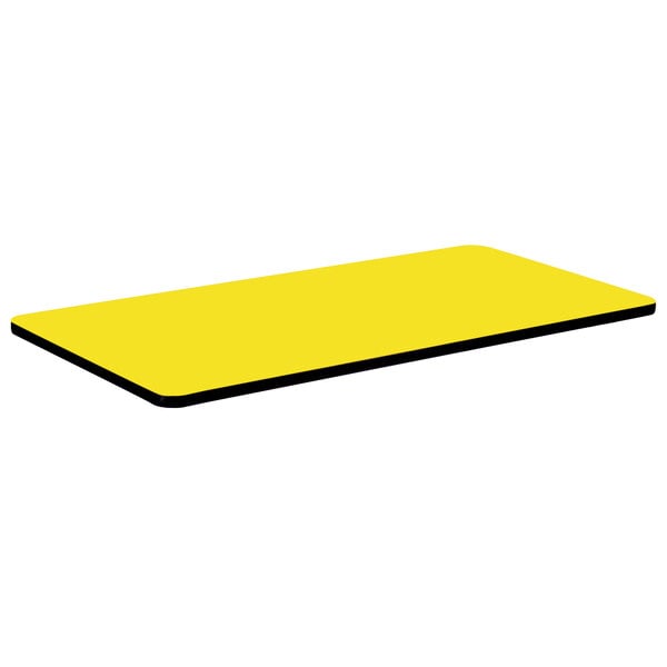 A yellow rectangular Correll table top with black edges.