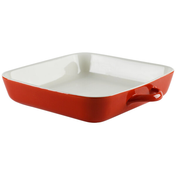 A red and white square pan with a white handle.