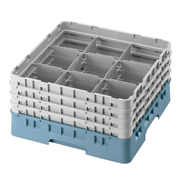 A teal plastic Cambro glass rack with 9 compartments and 6 extenders.