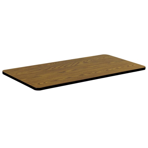 A rectangular medium oak Correll table top with a black edge.