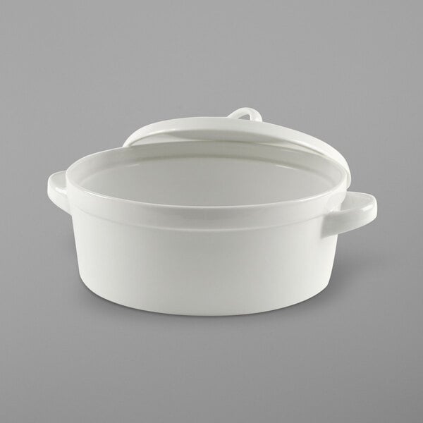 A white round porcelain baker with a lid.