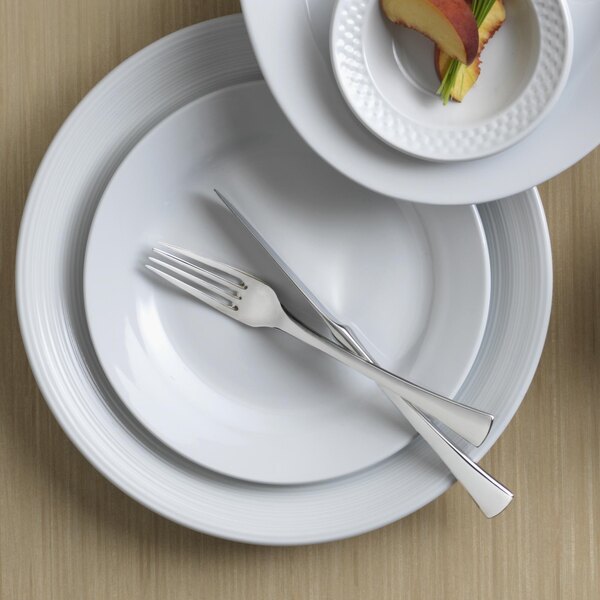 A white plate with a Reserve by Libbey stainless steel dinner knife and fork on it.