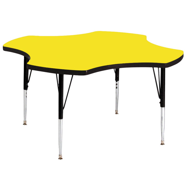 A yellow Correll clover-shaped activity table with black legs.