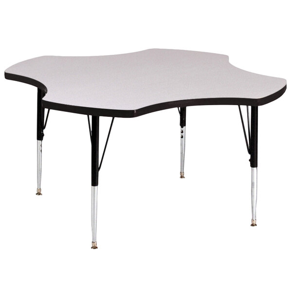 A gray granite Correll clover-shaped activity table with adjustable legs.