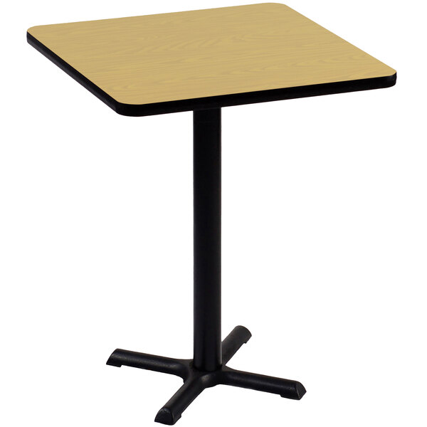 A Correll square table with a black base and a fusion maple top.