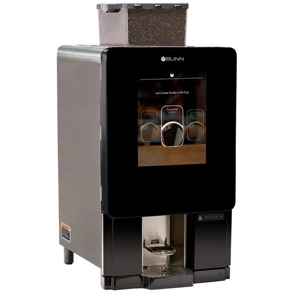 A Bunn Sure Immersion single cup coffee brewer on a counter with a screen on it.