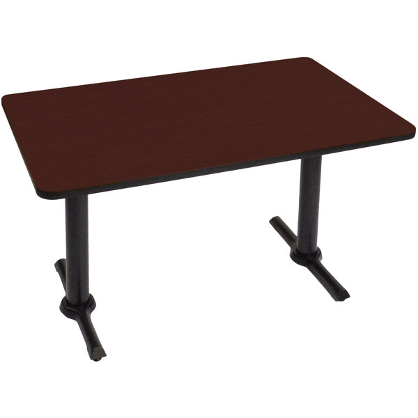 A brown rectangular table with black T bases.