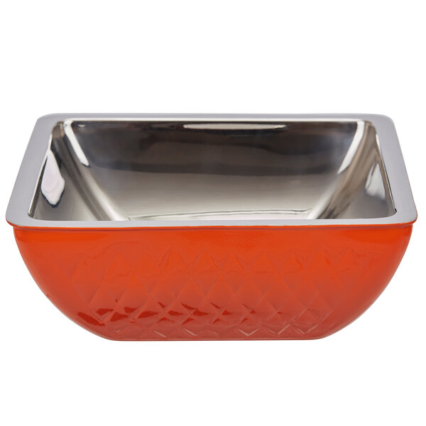 An orange and silver Bon Chef square bowl with metal trim on a counter.
