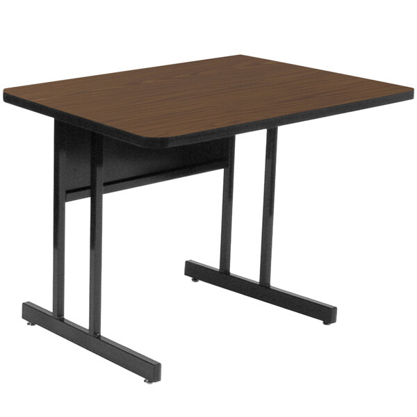 A brown rectangular desk with black legs.