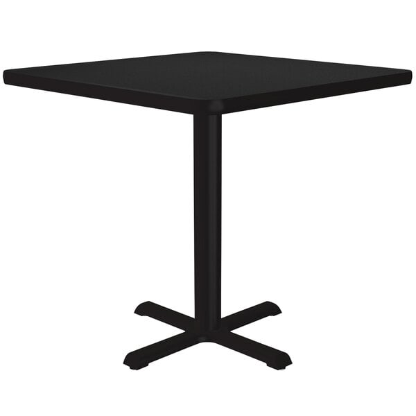 A black Correll square table on a metal base.