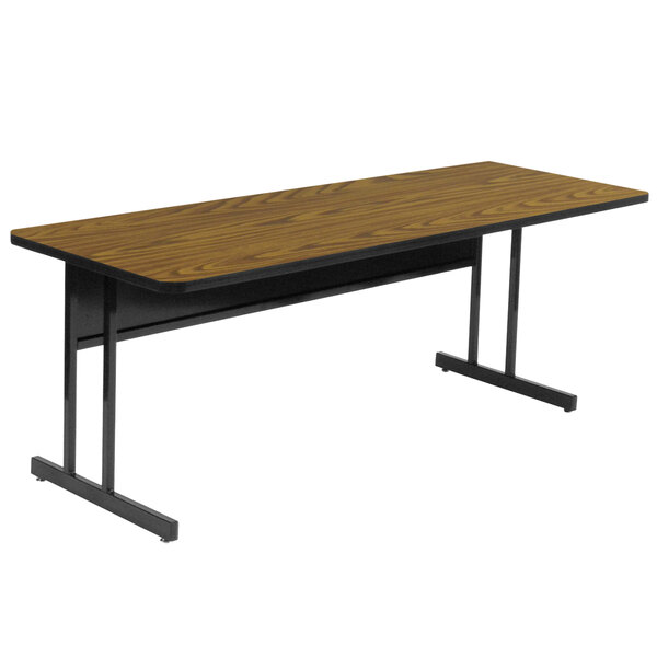 A rectangular medium oak desk with a black frame.