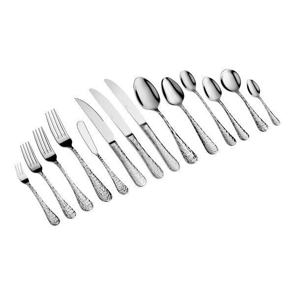 A set of various stainless steel utensils, including forks, knives, and spoons, arranged in a row on a white background.