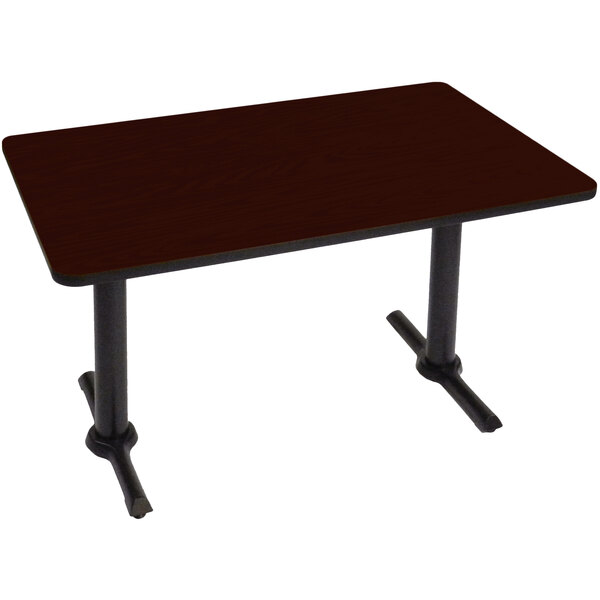 A mahogany rectangular table with two black T bases.