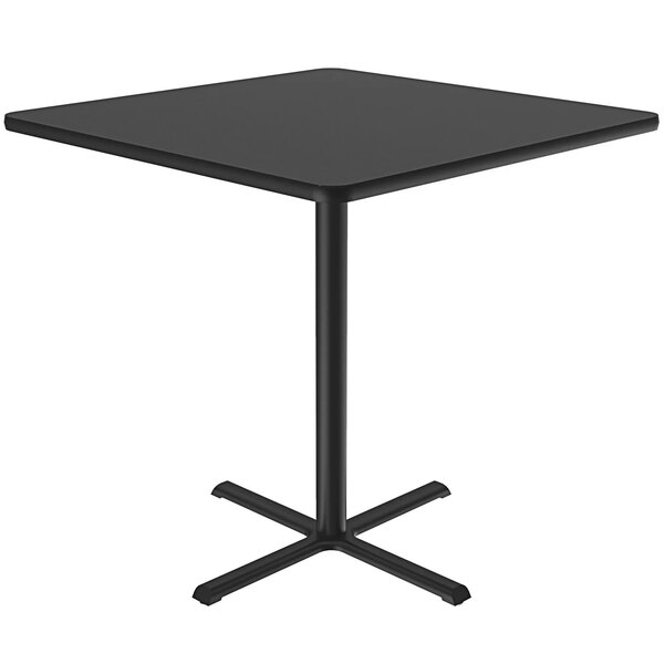 A Correll black square bar height table with a metal base.