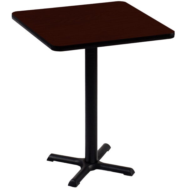 A Correll square bar height table with a mahogany top and black base.