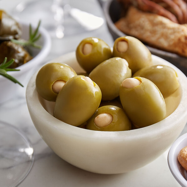 A bowl of Belosa almond and jalapeno stuffed green olives on a white plate.