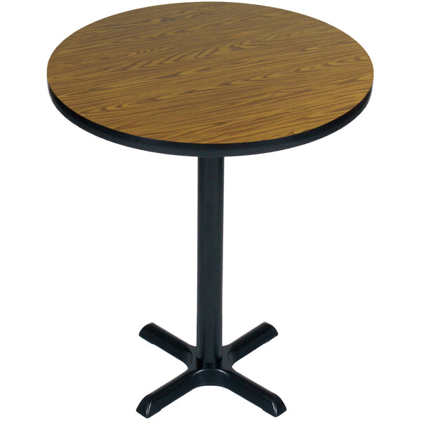 A round wooden Correll table with a black base.