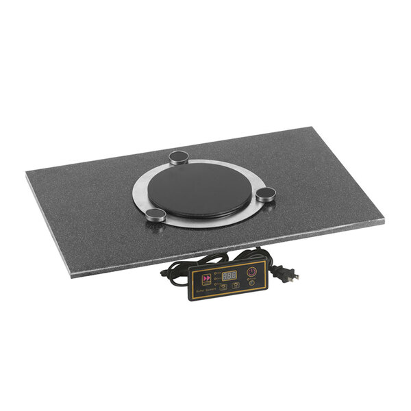 A black square Corian countertop adapter with a black and silver circular induction heating element inside.