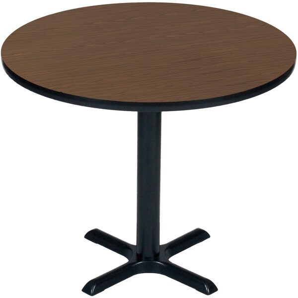 A Correll round table with a black base and a walnut top.