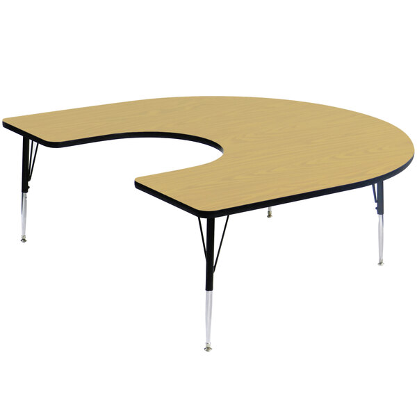 A Correll horseshoe-shaped activity table with adjustable legs.