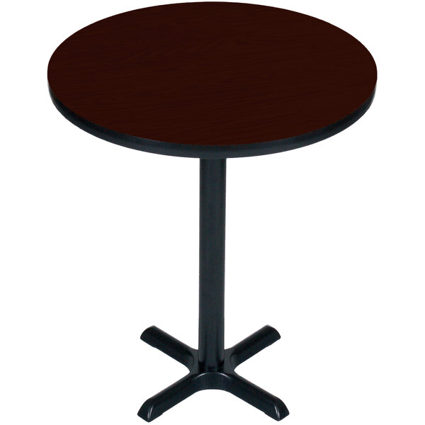 A Correll round mahogany bar height table with a black base.