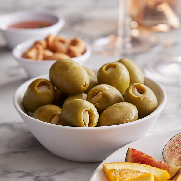 A bowl of Belosa Lemon Peel Stuffed green olives on a table.